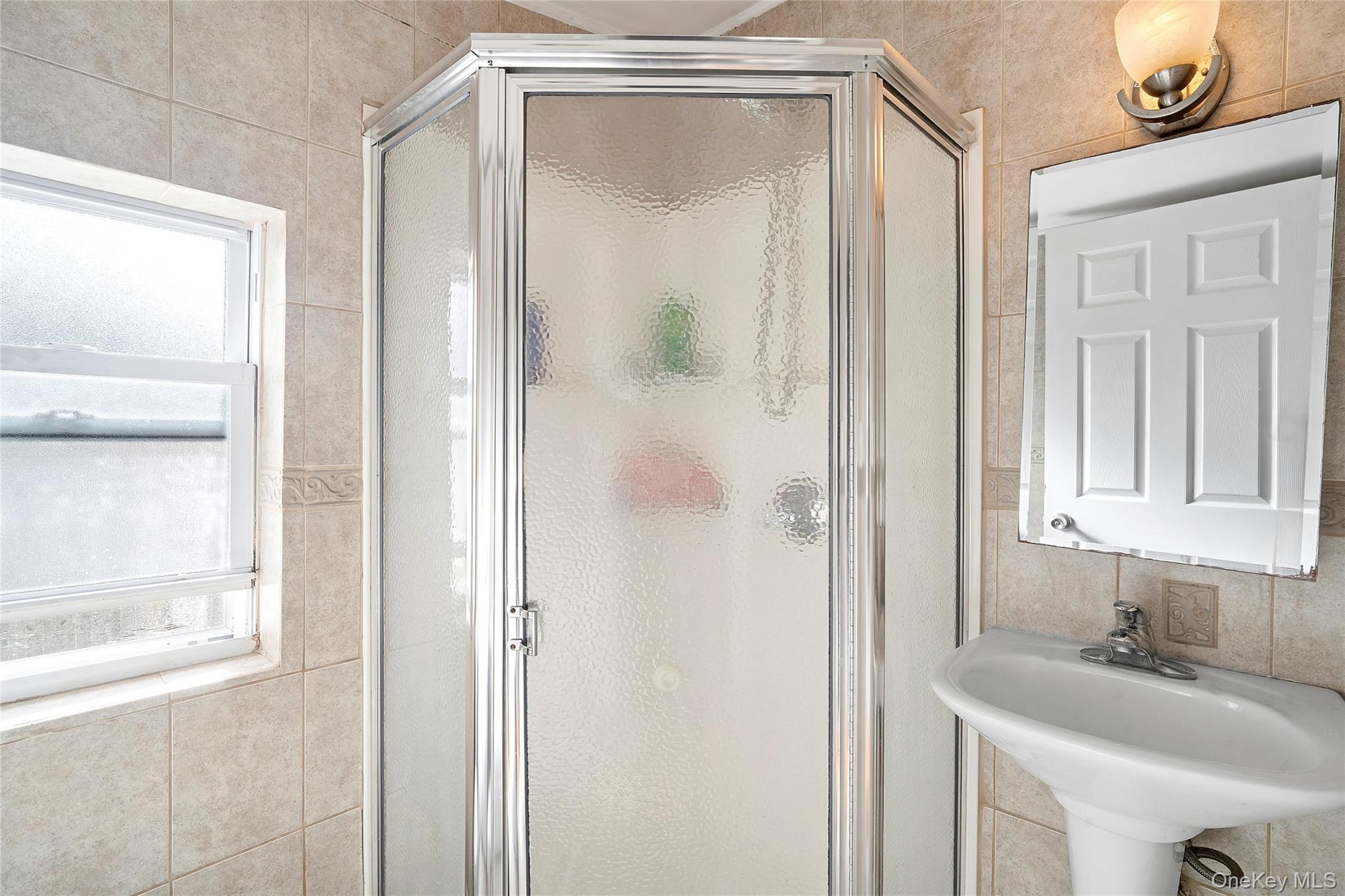 69 Locust Drive Mastic Beach, NY 11951 - Photo 8 of 13 a bathroom with a granite countertop sink mirror and vanity