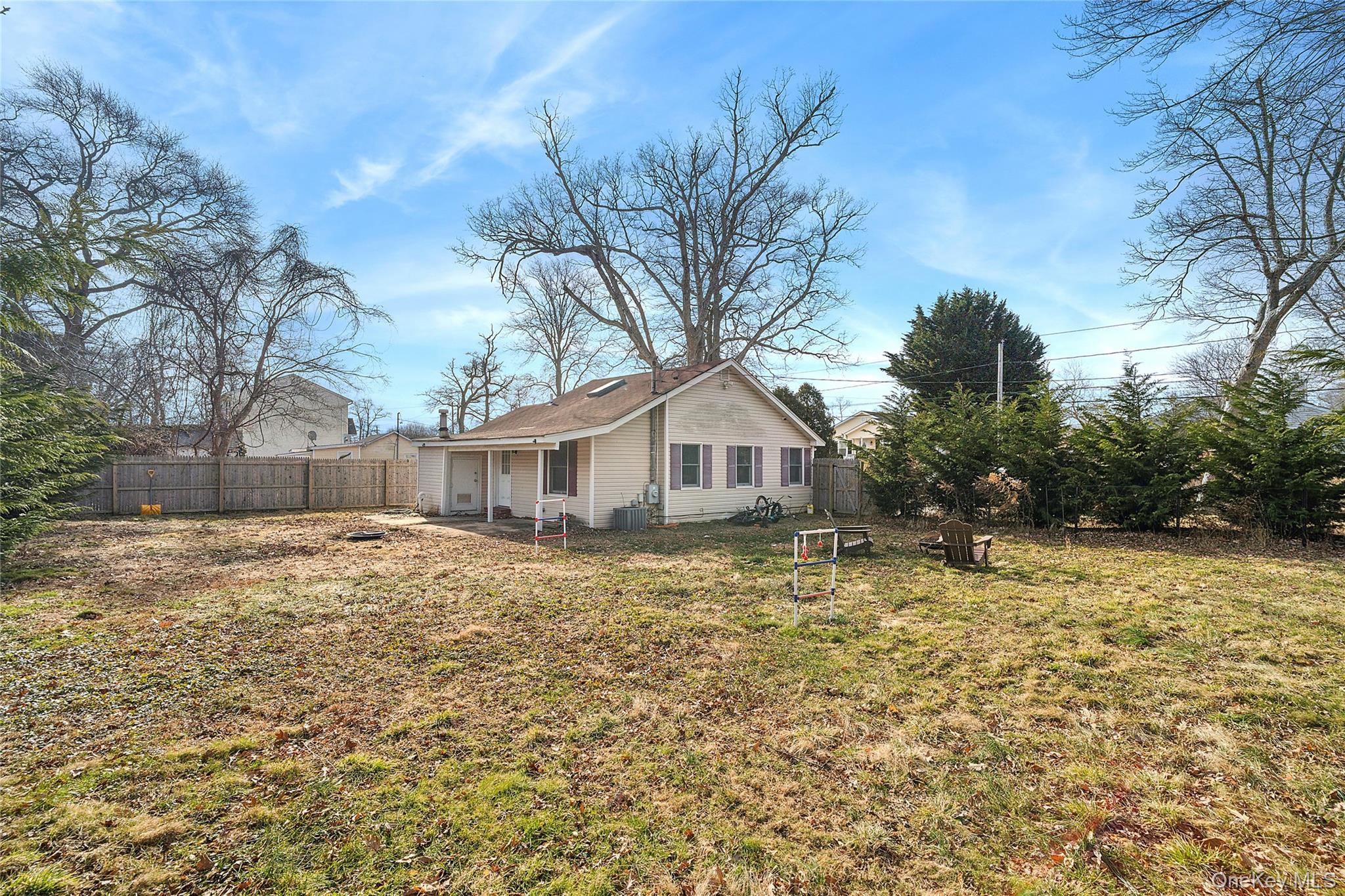 69 Locust Drive Mastic Beach, NY 11951 - Photo 10 of 13 a white house that has a tree in front of it