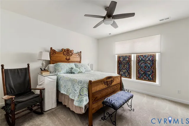 a bathroom with a sink a toilet a mirror and shower