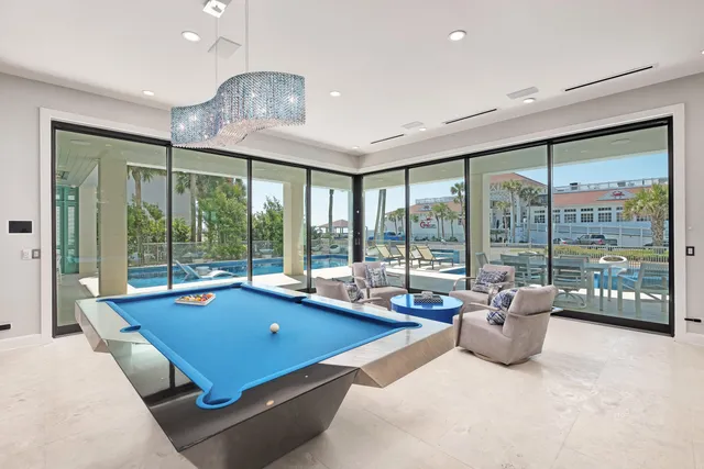 a room with pool table and windows