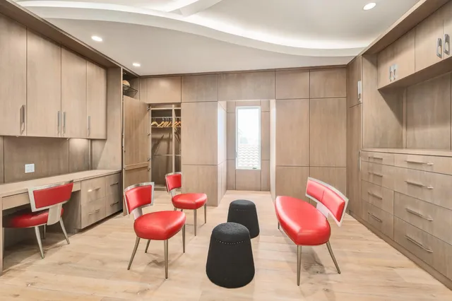 a bedroom with furniture and a flat screen tv