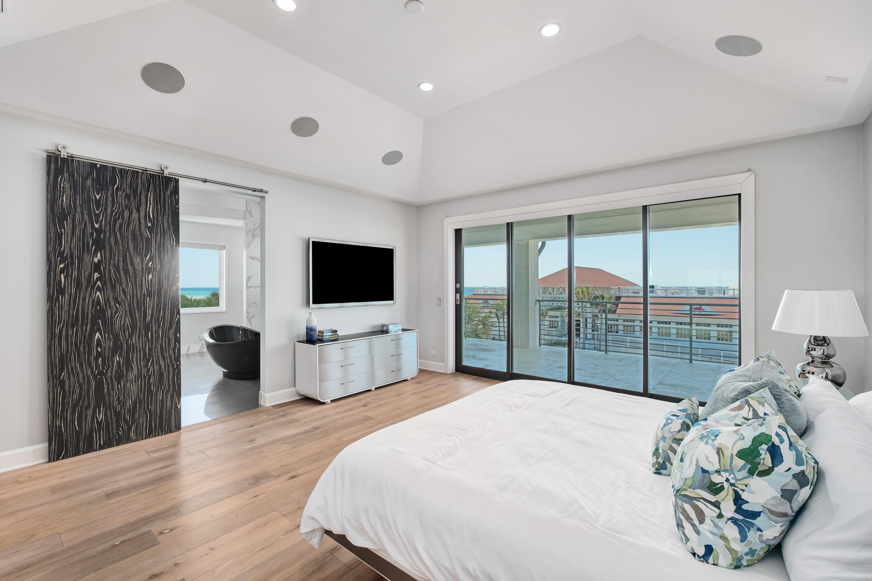 4662 Destiny Way Destin, FL 32541 - Photo 35 of 67 a large bedroom with a bed and a flat tv screen on dresser