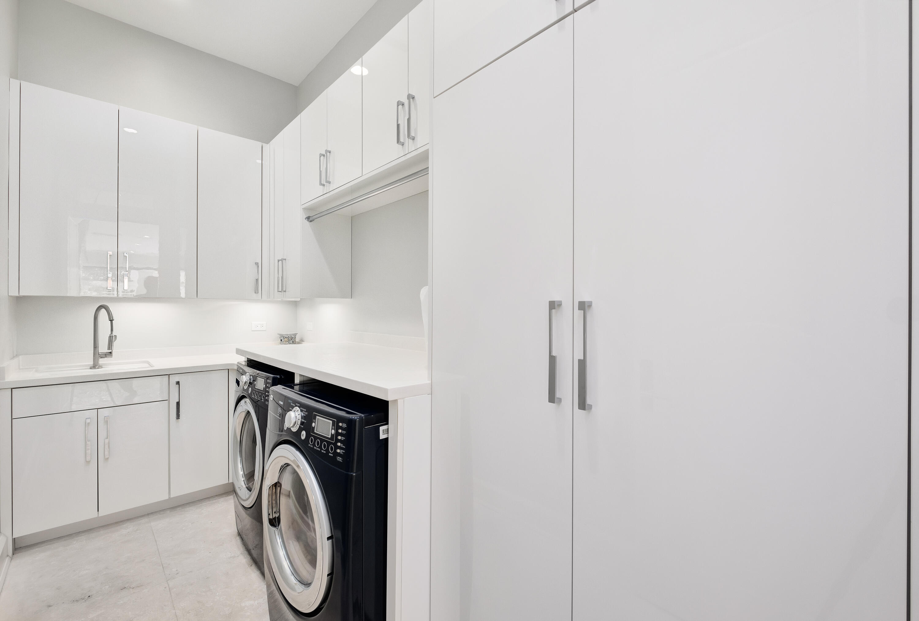 4662 Destiny Way Destin, FL 32541 - Photo 47 of 67 a utility room with cabinets washer and dryer