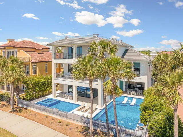 a view of swimming pool with outdoor seating and plants