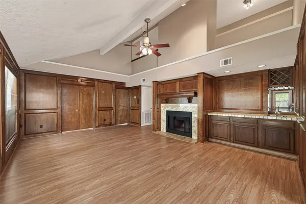 a view of a kitchen with cabinets and wooden floor