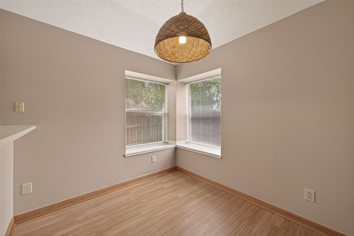5003 Dawn Lily Drive Spring, TX 77388 - Photo 16 of 49 an empty room with wooden floor and windows