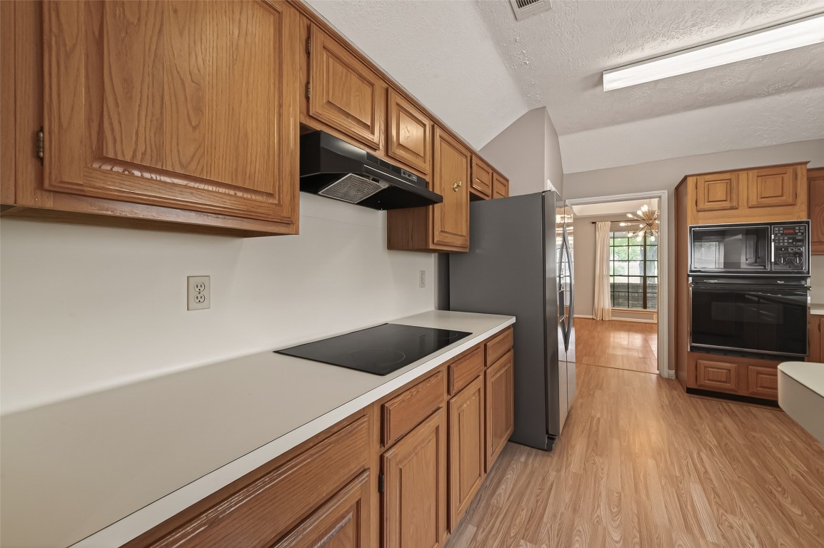 5003 Dawn Lily Drive Spring, TX 77388 - Photo 18 of 49 a kitchen with stainless steel appliances granite countertop a sink and wooden cabinets