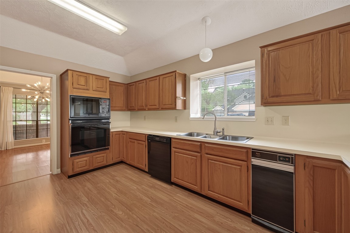 5003 Dawn Lily Drive Spring, TX 77388 - Photo 19 of 49 a kitchen with stainless steel appliances granite countertop a stove a sink and a microwave