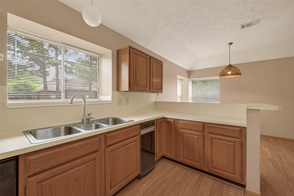 5003 Dawn Lily Drive Spring, TX 77388 - Photo 20 of 49 a kitchen with a sink window and cabinets