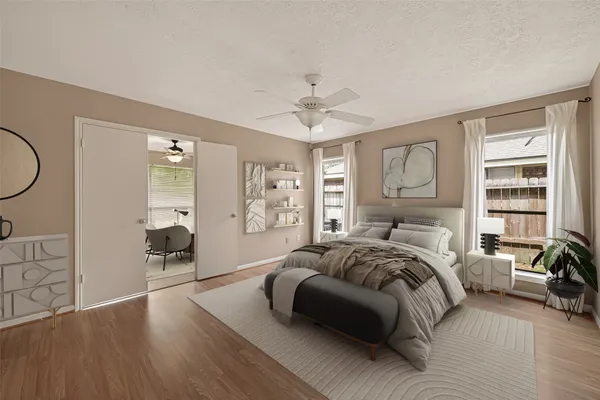 an empty room with a chandelier fan and windows