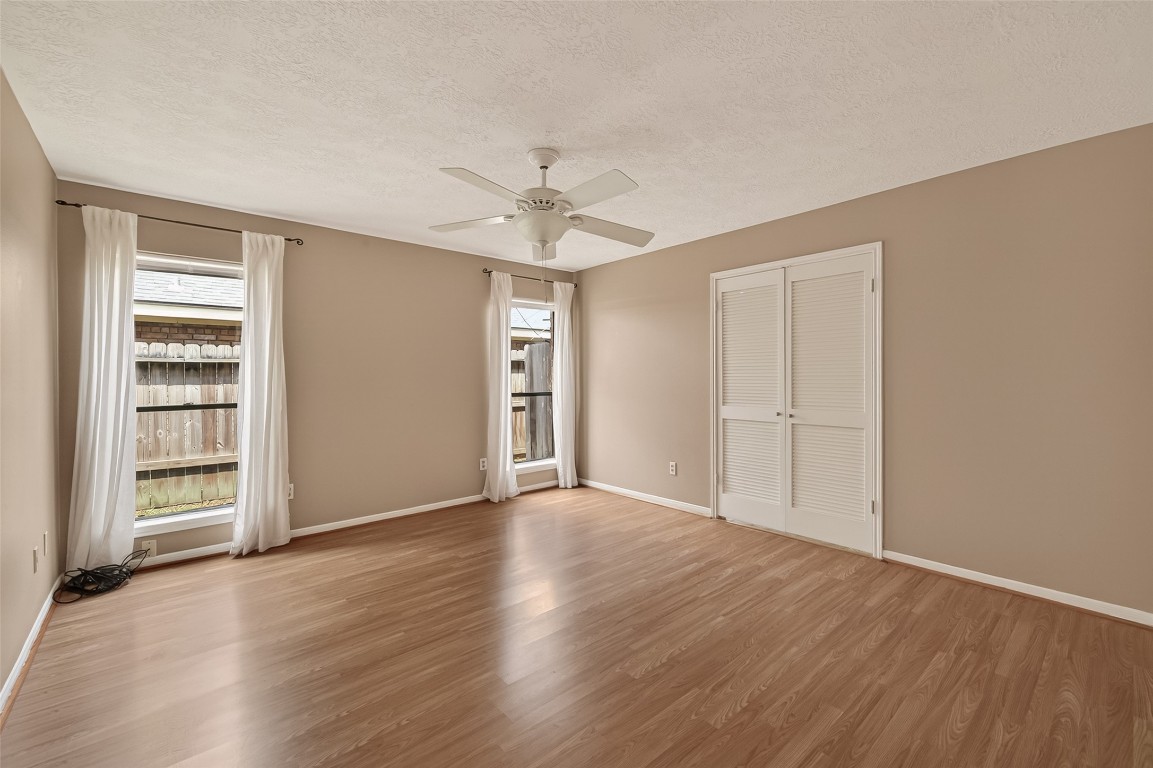 5003 Dawn Lily Drive Spring, TX 77388 - Photo 30 of 49 a view of an empty room with a window and wooden floor