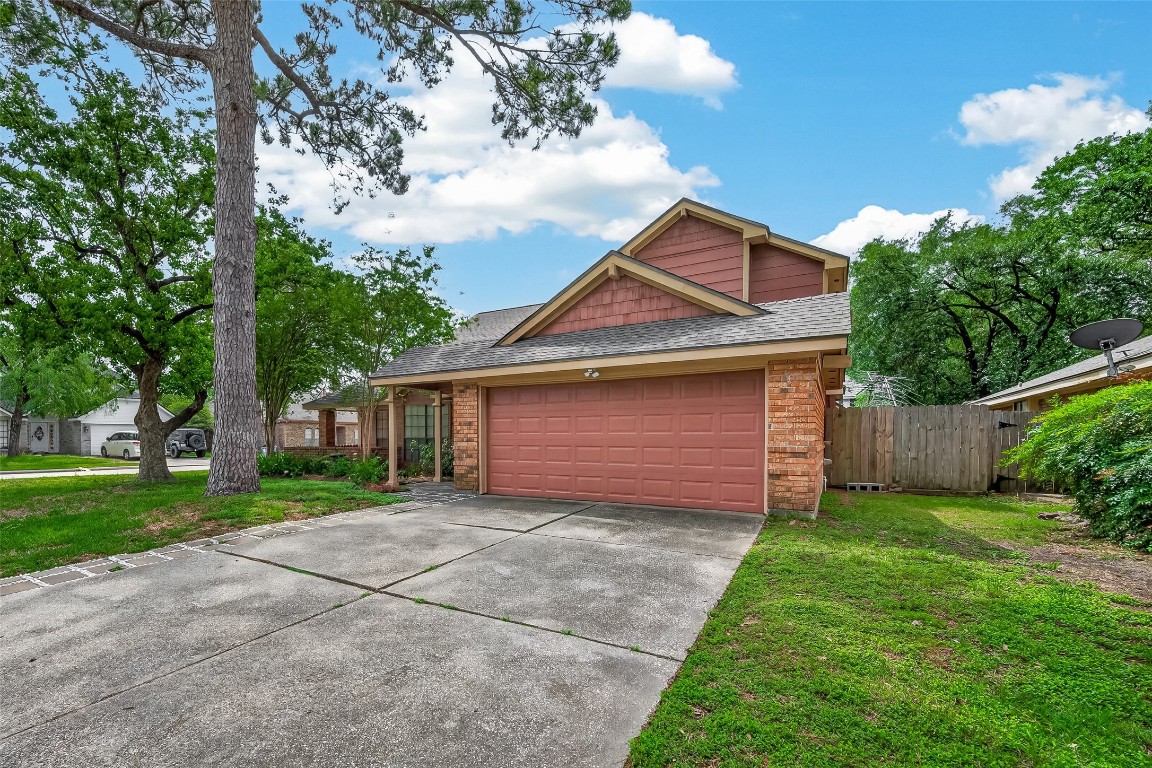 5003 Dawn Lily Drive Spring, TX 77388 - Photo 3 of 49 a front view of a house with a yard and garage