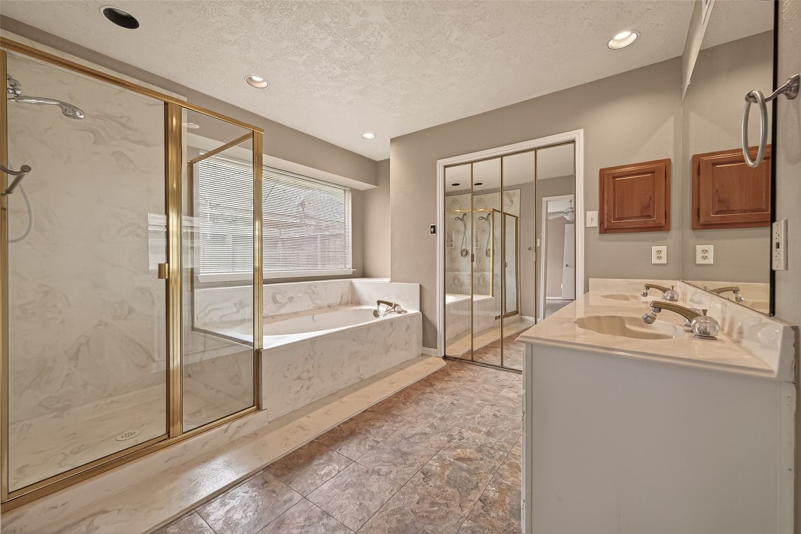 5003 Dawn Lily Drive Spring, TX 77388 - Photo 32 of 49 a bathroom with a tub sink and mirror