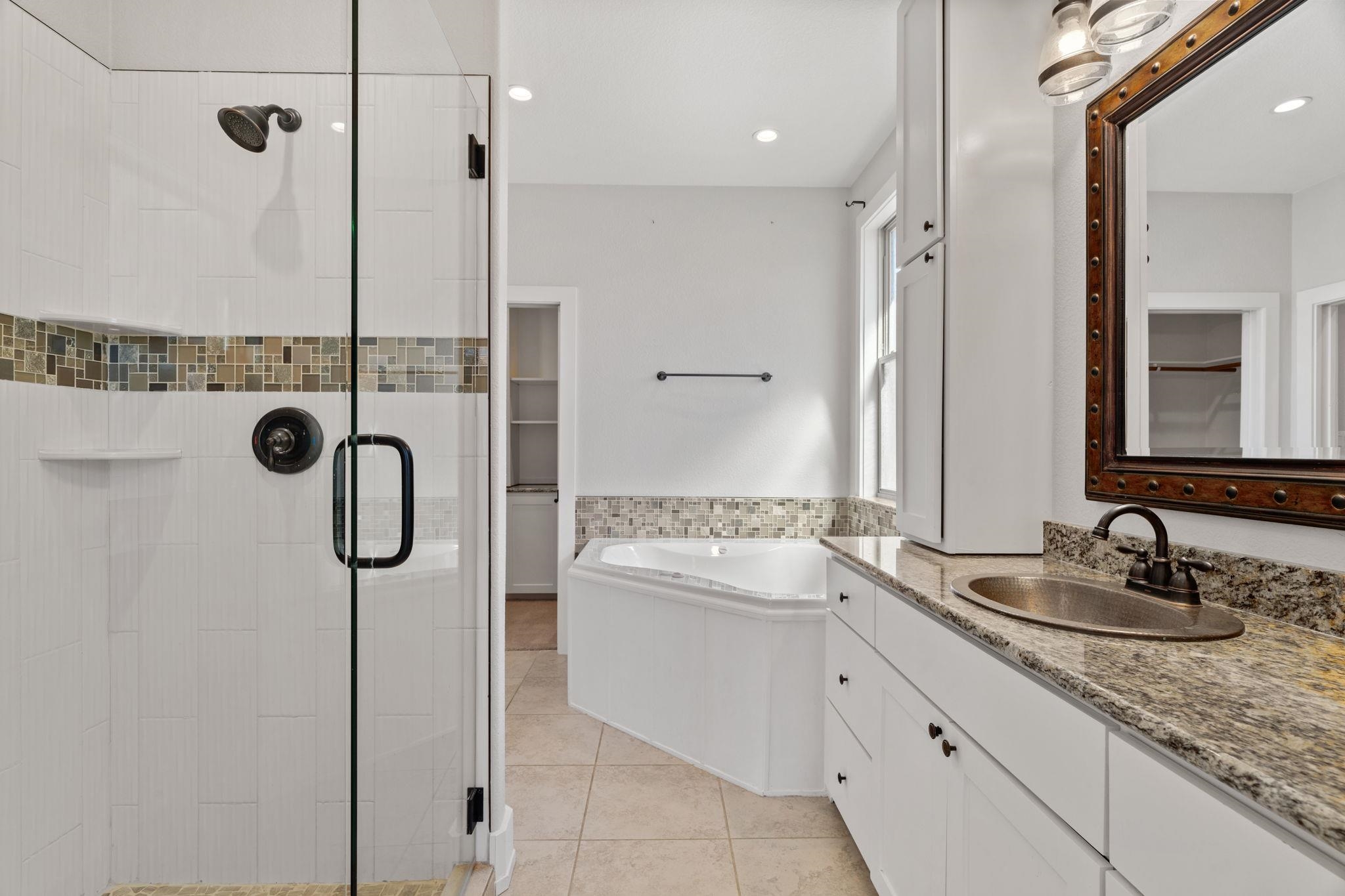 110 Chaumont Street Kingsland, TX 78639 - Photo 16 of 29 a bathroom with a granite countertop sink mirror and shower