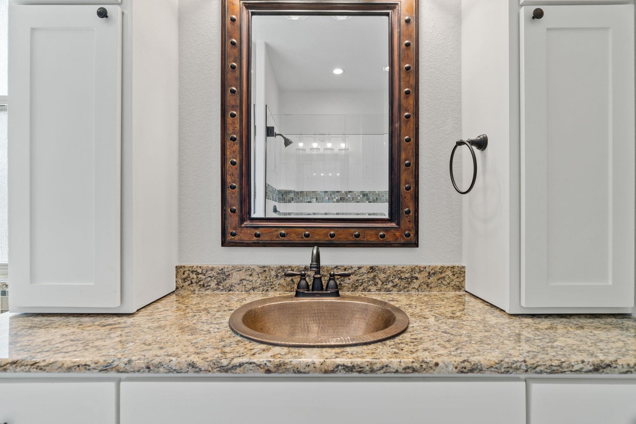 110 Chaumont Street Kingsland, TX 78639 - Photo 18 of 29 a bathroom with a granite countertop sink and a mirror