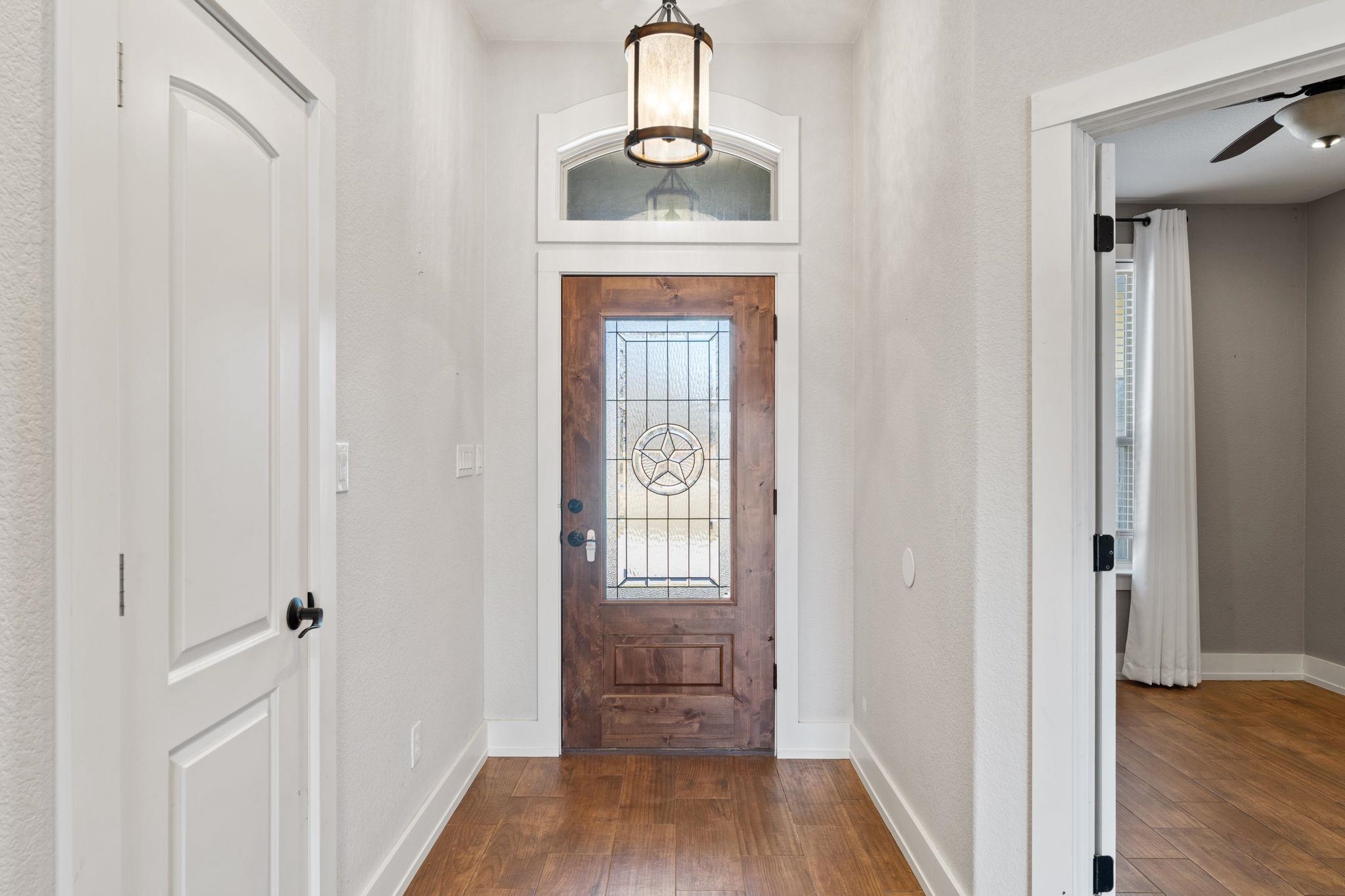 110 Chaumont Street Kingsland, TX 78639 - Photo 2 of 29 a view of a hallway with wooden floor and entryway