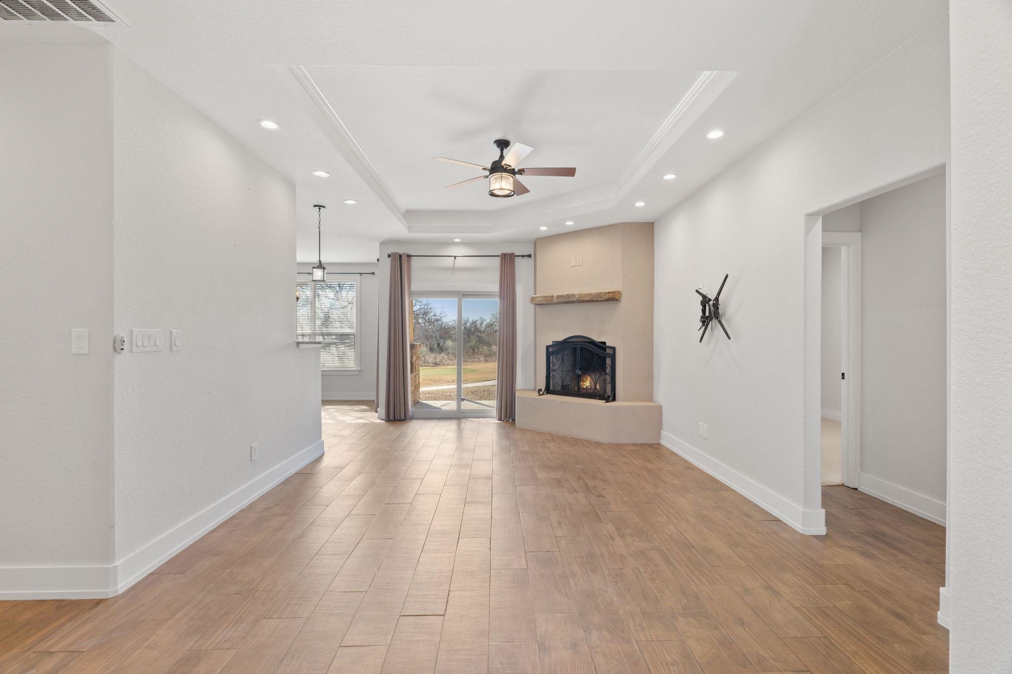 110 Chaumont Street Kingsland, TX 78639 - Photo 4 of 29 an empty room with windows and fireplace