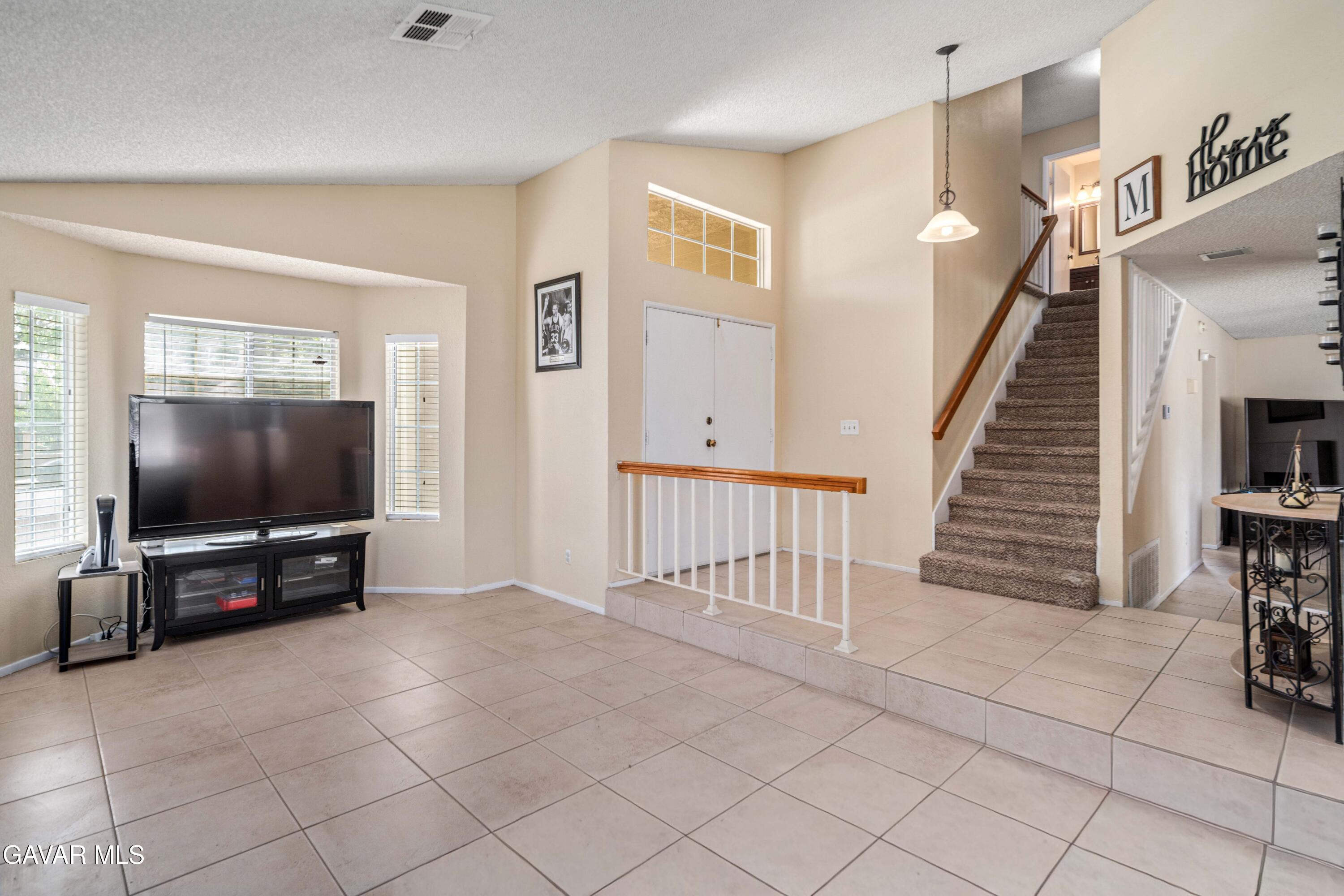 1605 Bluebell Street Lancaster, CA 93535 - Photo 9 of 40 a living room with furniture and a flat screen tv