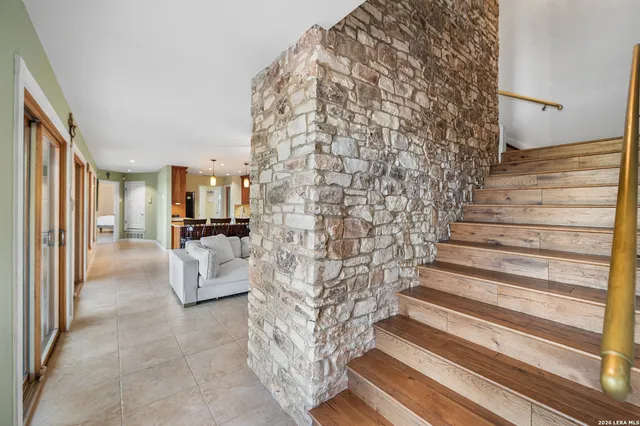 a spacious bedroom with a bed and a chair