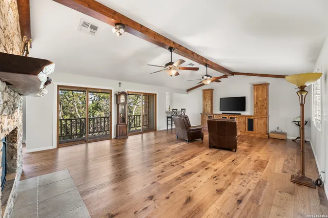 a view of backyard with seating space and trees