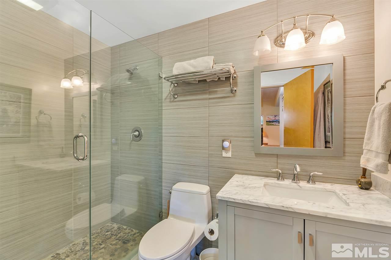 253 Cheyenne Circle Zephyr Cove, NV 89448 - Photo 15 of 25 a bathroom with a granite countertop sink toilet and shower