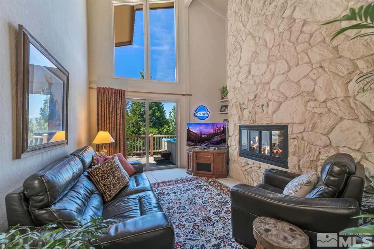 253 Cheyenne Circle Zephyr Cove, NV 89448 - Photo 8 of 25 a living room with furniture a flat screen tv and a fireplace