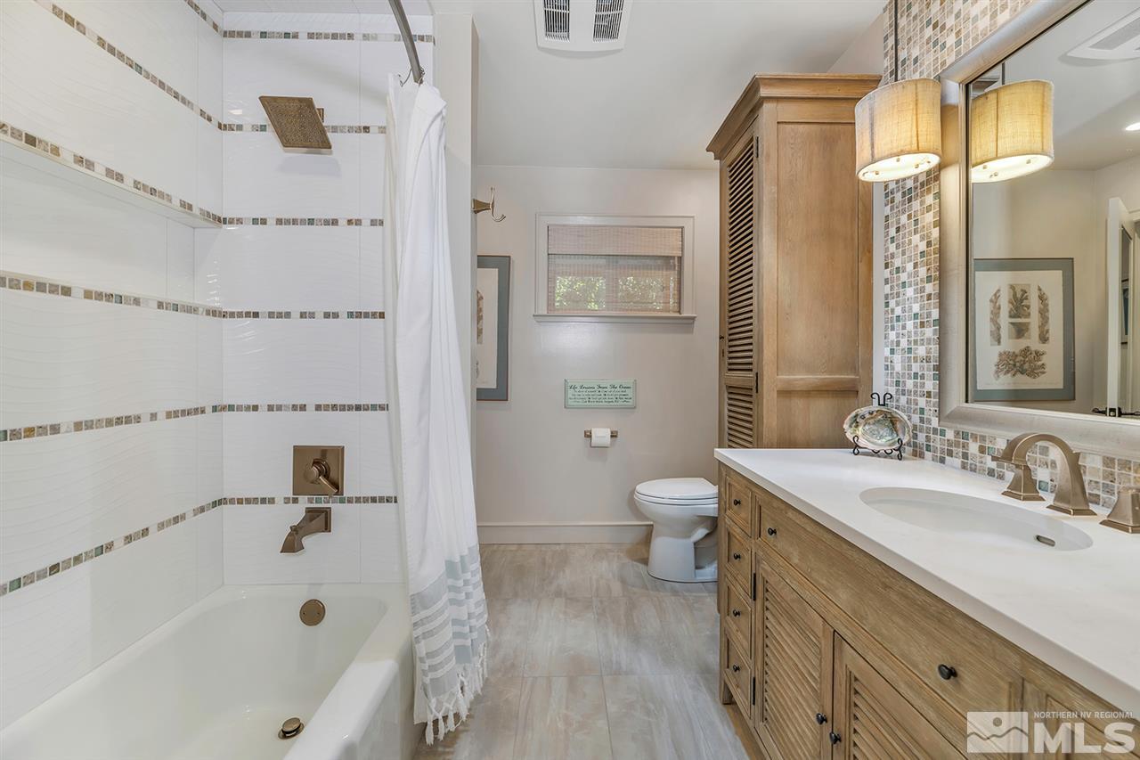 253 Cheyenne Circle Zephyr Cove, NV 89448 - Photo 10 of 25 a bathroom with a tub sink and a mirror