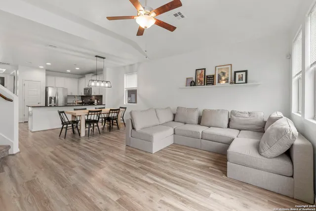a living room with furniture and kitchen view