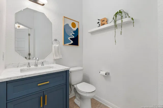 a bathroom with a sink a toilet and mirror