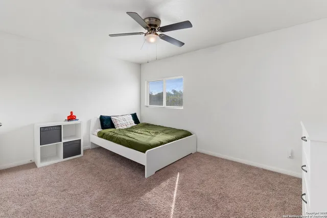 a bedroom with furniture and window