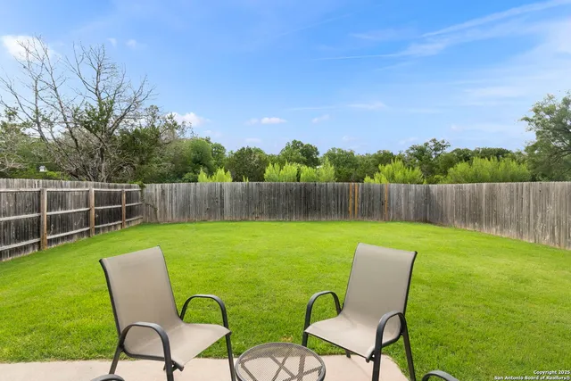 a view of a chairs in backyard of the house