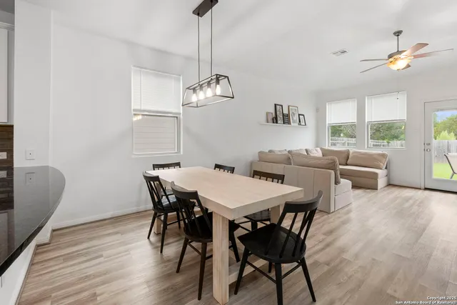 a view of a dining room with furniture window and wooden floor