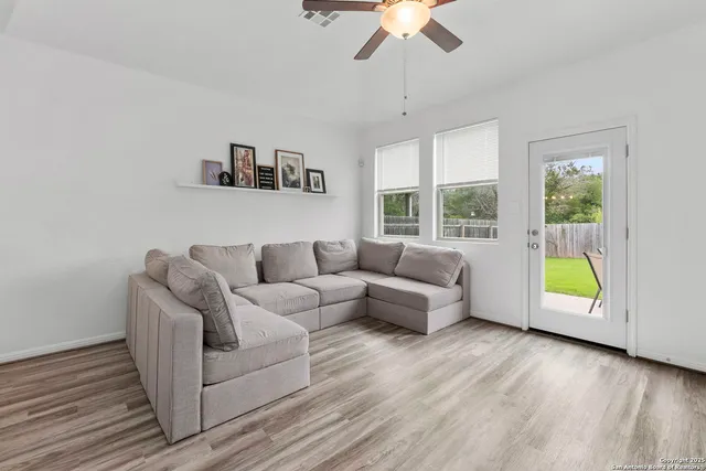 a living room with furniture and a wooden floor