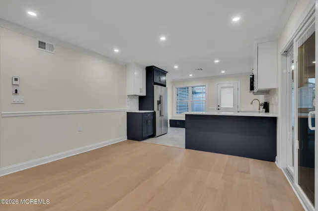 a view of kitchen with stainless steel appliances kitchen island