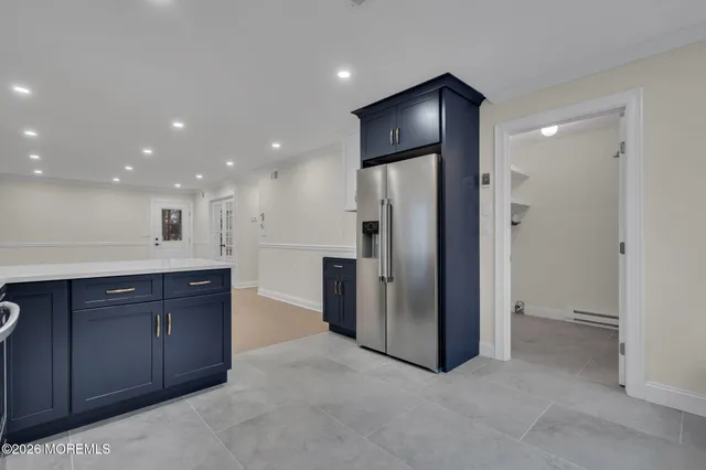 a kitchen with stainless steel appliances granite countertop a refrigerator and a sink