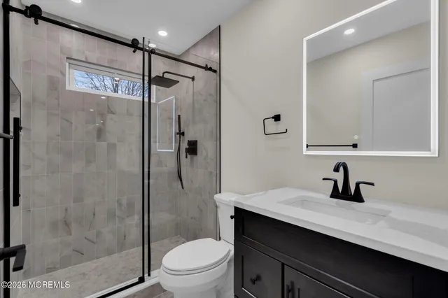 a bathroom with a shower toilet and sink