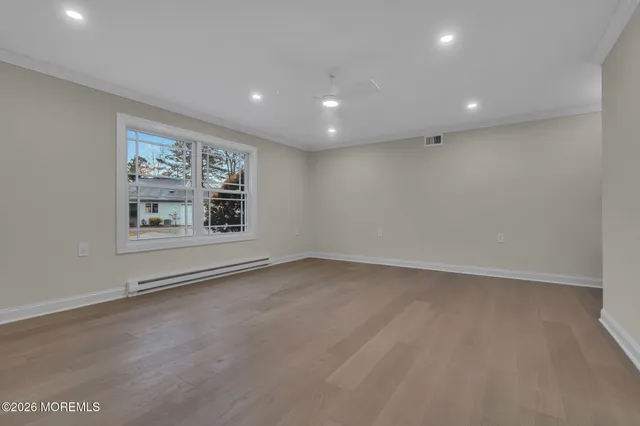 an empty room with closet and windows