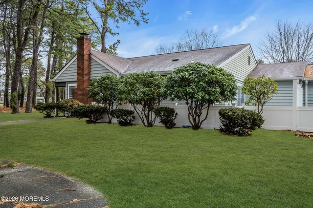 a front view of a house with a garden and yard