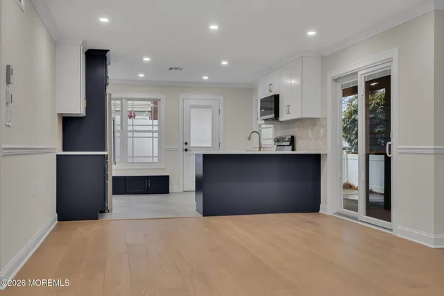 a kitchen with kitchen island a sink stainless steel appliances and counter space