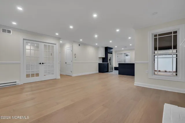 a view of an empty room with a kitchen