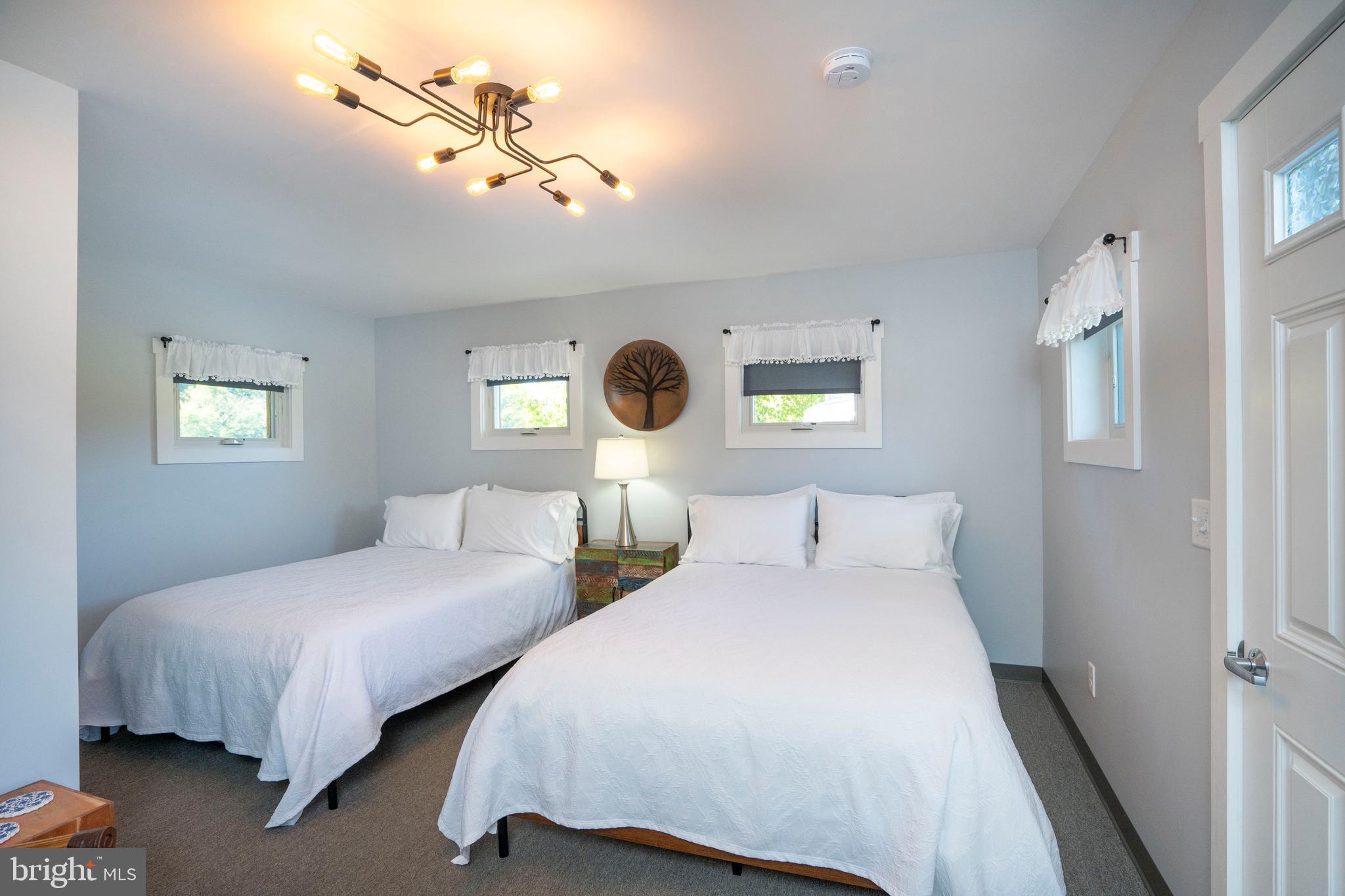 66 Front Drive Mount Union, PA 17066 - Photo 37 of 93 a bedroom with two beds and a chandelier