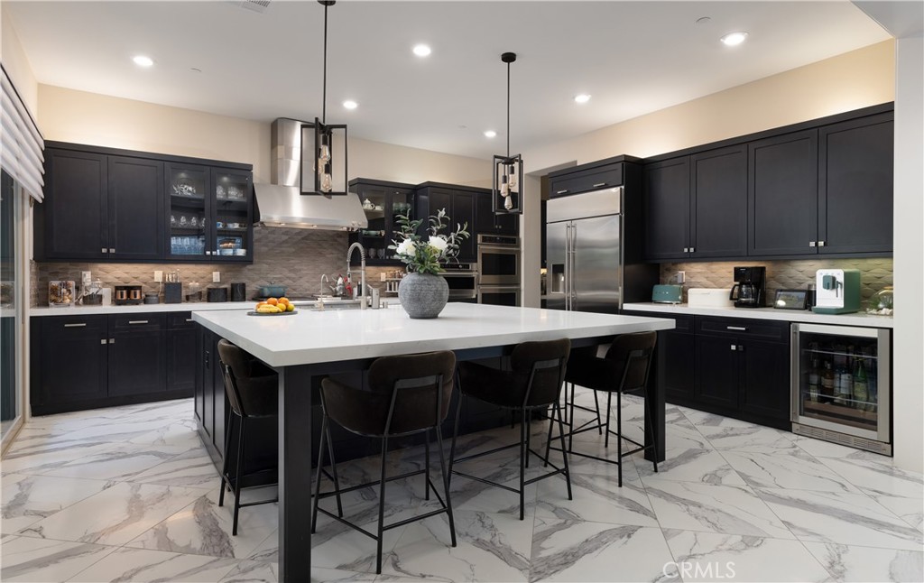 93 Turnstone Irvine, CA 92618 - Photo 14 of 52 a kitchen with a sink a cabinets and chairs