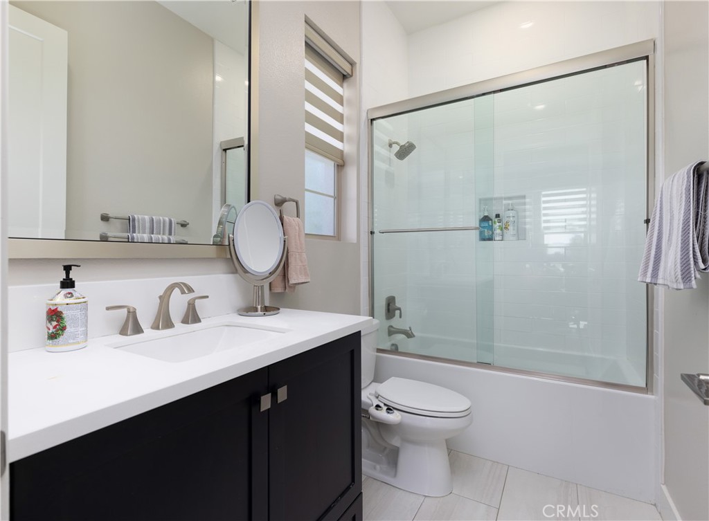 93 Turnstone Irvine, CA 92618 - Photo 19 of 52 a bathroom with a double vanity sink toilet mirror and shower