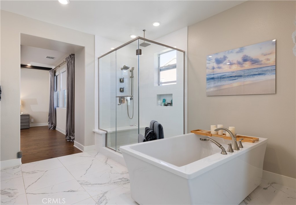 93 Turnstone Irvine, CA 92618 - Photo 24 of 52 a spacious bedroom with a bed and a chandelier