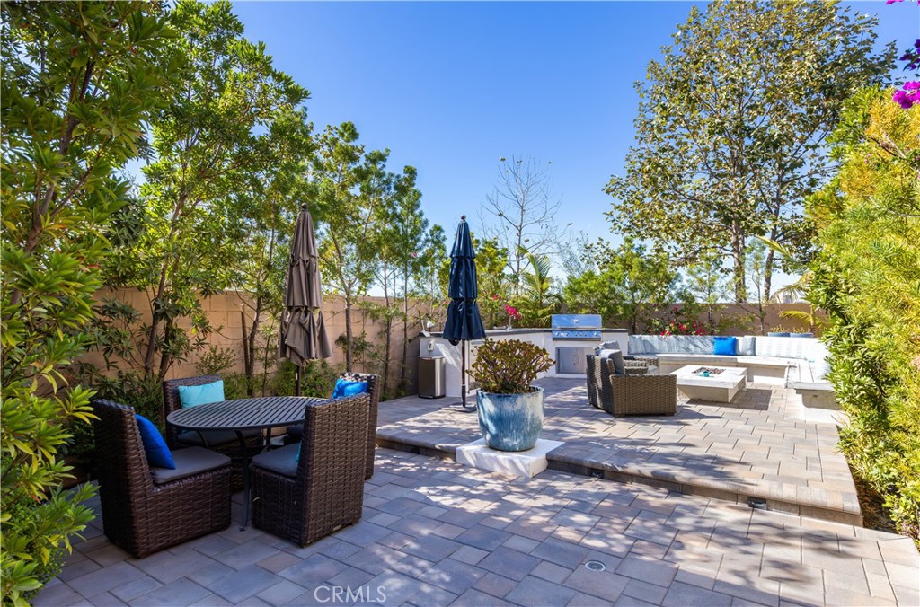 93 Turnstone Irvine, CA 92618 - Photo 37 of 52 a view of a patio with couches potted plants and a large tree