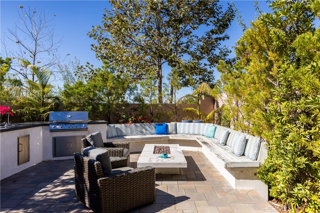 93 Turnstone Irvine, CA 92618 - Photo 38 of 52 a view of a patio with couches table and chairs with wooden fence and plants