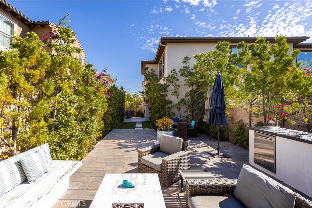 93 Turnstone Irvine, CA 92618 - Photo 40 of 52 a view of a patio with couches table and chairs and potted plants