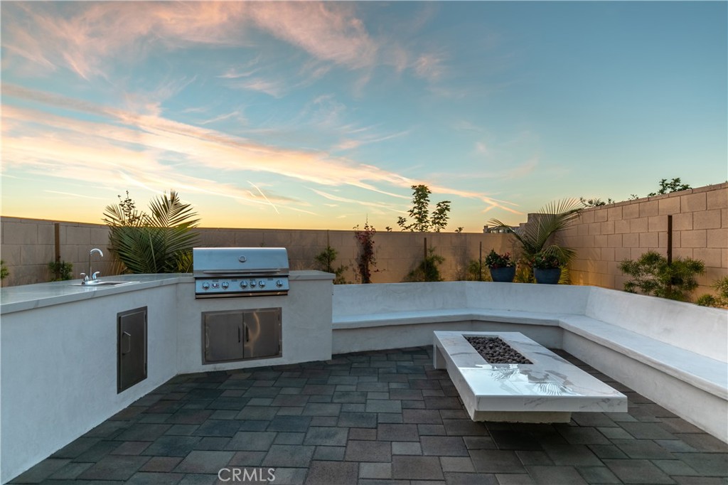 93 Turnstone Irvine, CA 92618 - Photo 49 of 52 a terrace with a bench and chairs