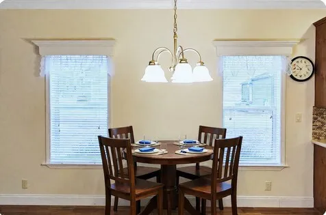 a view of a dining room with furniture and window