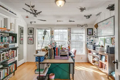 a living room with lots of furniture and a book shelf